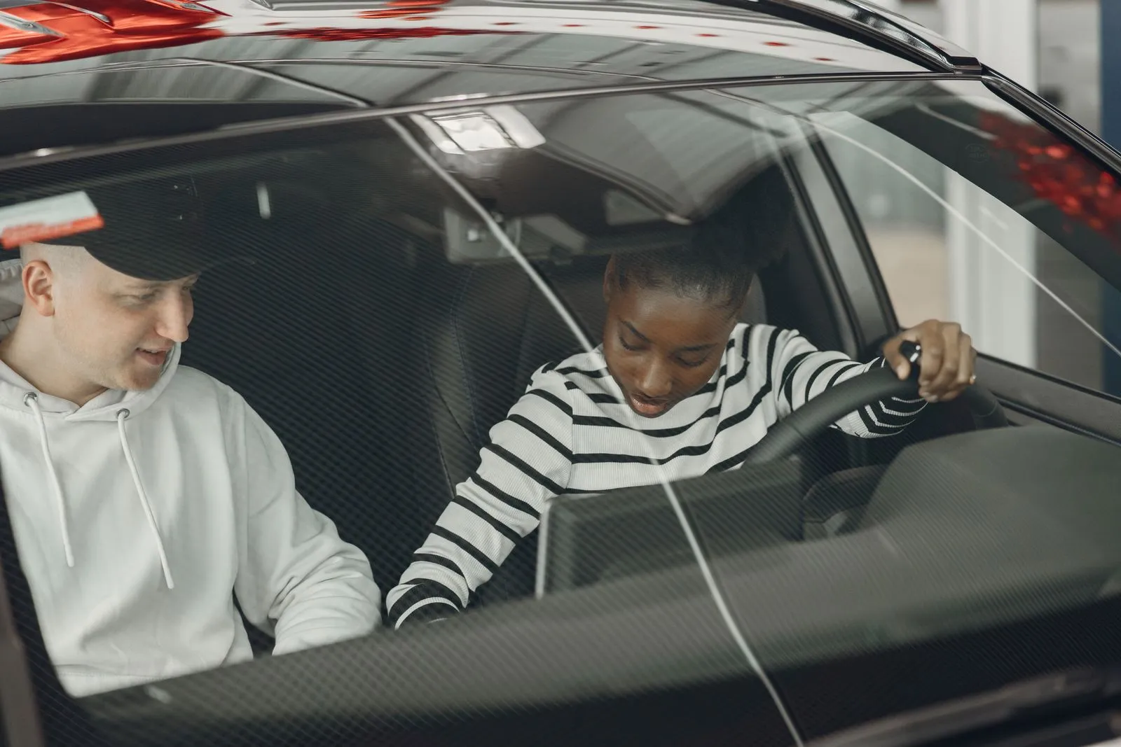 Driving instructor sitting beside an adult learner driver