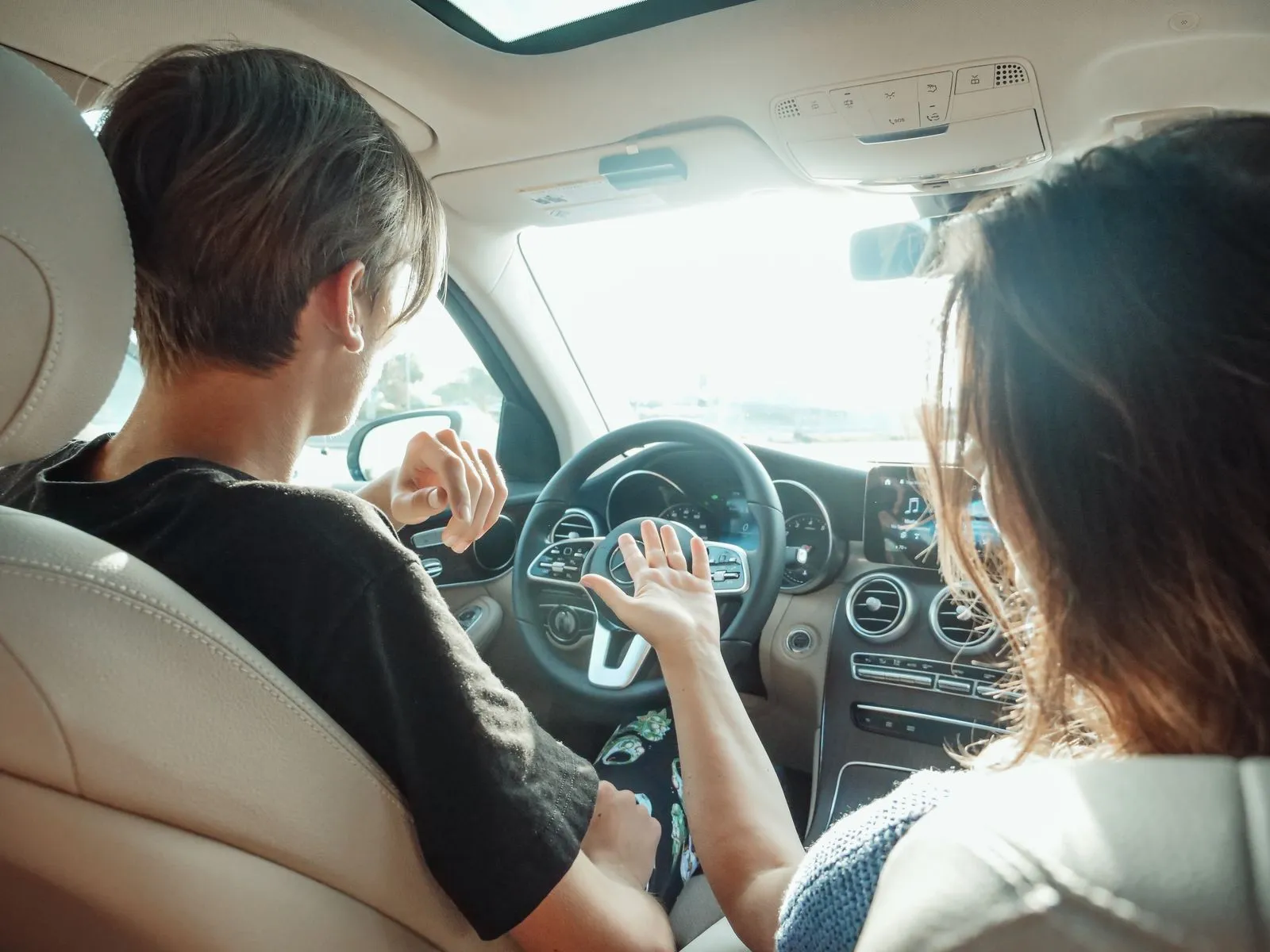 Instructor explaining the car controls to an adult student